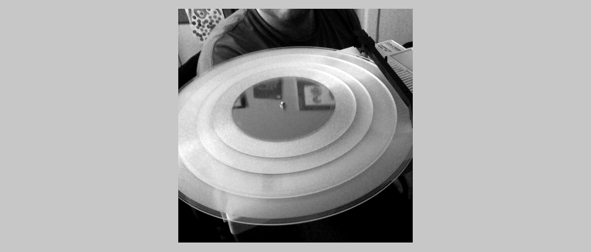 A set of 4 records designed to stack into a playlist — played backwards to travel from the inside out, with complementary program material that forms a full stereo composition when played together.